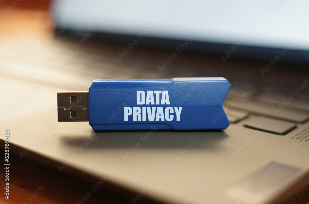 Poster on the laptop keyboard is a flash drive with the inscription - data privacy