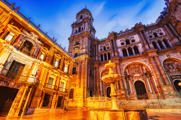 Fototapeta na wymiar Illuminated Malaga Cathedral from Plaza Del Obispo at Dusk in Malaga, Andalusia