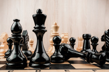 Black and white wooden chess pieces is on classic chessboard. Business strategy and planning...