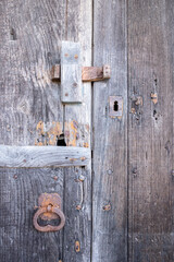 deep old and weathered door with traditional locking system, vertical
