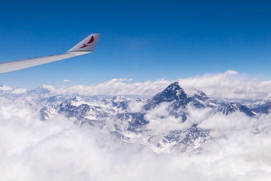Avianca airplane in the sky flying by Andes Mountains, Chile trip