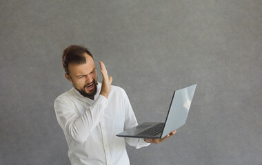 Eww yucky, don't wanna see it. Displeased angry man trying to ignore cyberbullying doing STOP hand gesture at laptop computer. Young guy covers face aghast at repulsive horrible quality online content - obrazy, fototapety, plakaty