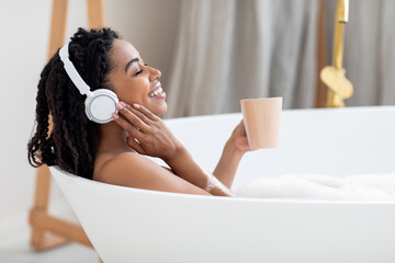 Beautiful Young Black Lady Taking Bath, Listening Music And Drinking Coffee