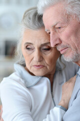 Close-up portrait of an elder couple at home