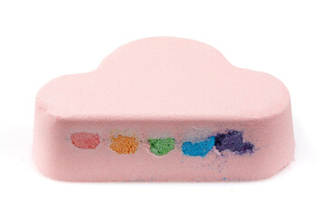 Bath salts in the form of a pink cloud, with a multi-colored filler. Isolated object. Close-up.