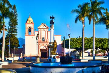 church with font in first plane and palm trees around in xalisco, nayarit 