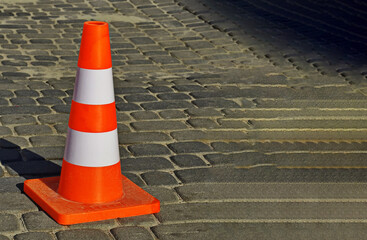 Traffic cone on the asphalt road .