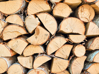 A stack of firewood, log ends, chopped birch and pine firewood. Texture, close up