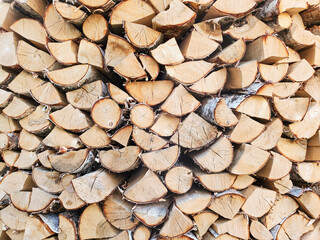 A stack of firewood, log ends, chopped birch and pine firewood, texture