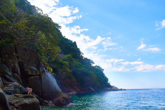 Young Girl Sit In Front Of Turquoise Seawith Blue Sky In Colomitos Beach, Boca De Tomatlan, Puerto Vallarta Jalisco 