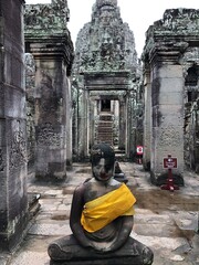 Walkway into The Bayon with Seated Buddha in Foreground