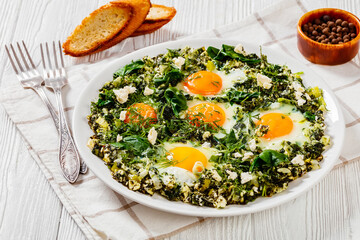 green shakshuka on white plate, top view