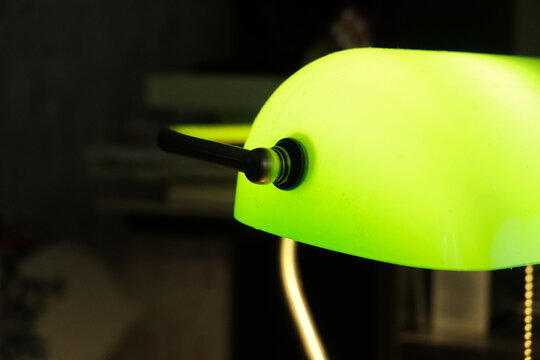 Green Table Lamp In A Dark Room