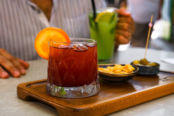 Fresh cold sangria cocktail on the table of the terrace of summer cafe.