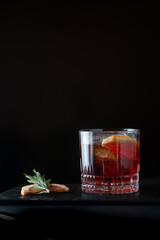negroni with garnish on black background