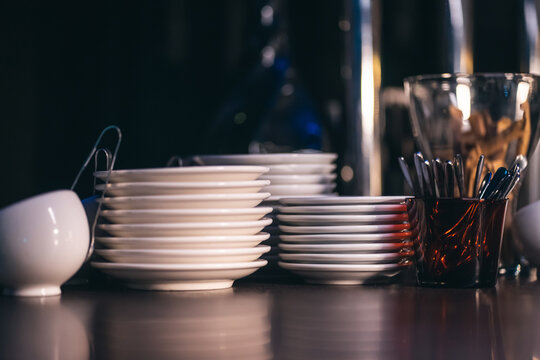 white plates and saucer set on brown wooden table, kitchenware