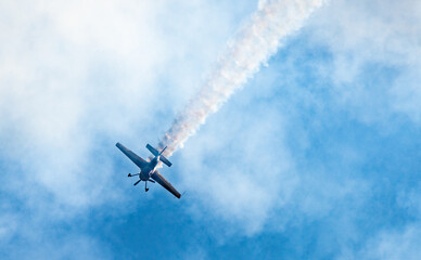 Fototapeta na wymiar Silhouettes of training aircraft performing aerobatics on a clear sunny day.