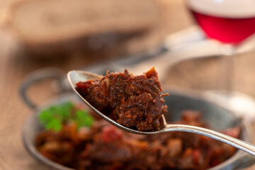 portion of austrian goulash on wood