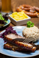 portion of fresh roasted pork on a blue plate