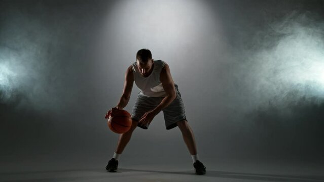 Super slow motion of basketball player dribbling. Filmed on high speed cinema camera, 1000fps. Speed ramp effect.