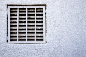 Gas fireplace on a wall decorated with white gotel&eacute;. Image with copy space