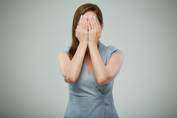 Fear concept. Woman hide her face with hands. isolated female portrait.