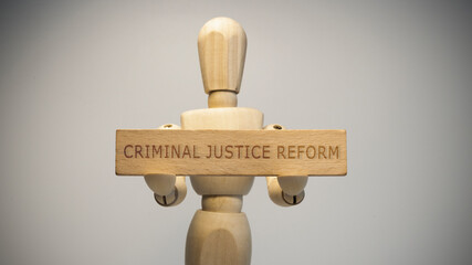 criminal justice reform written on wooden surface. Close-up in the studio. social issues.