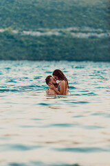Romantic couple kissing in the sea. High quality photo