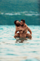 Fototapeta premium A sexy couple comes out of the sea after swimming. High quality photo