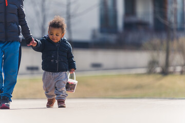 full shot of a little boy walking in the park, sunny day. High quality photo