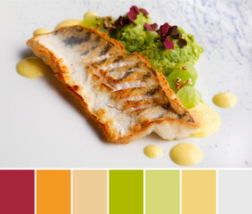 Color matching palette from close-up on grilled piece of fish with green puree, dark red edible plants, mustard sause and magenta radish sprouts on off white plate.