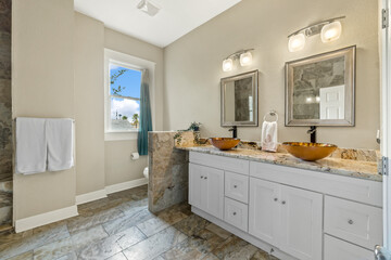 Bright interior of bathroom with window, wooden furniture and counter, round mirror and white brick wall. Simple and stylish design in scandinavian style.