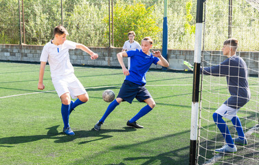 Football game - defender knocks ball from the attacker