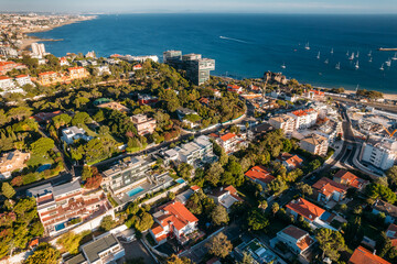 Fototapeta na wymiar Aerial drone view of Avenida Brasil in Cascais, Portugal, one of the most expensive street in Portugal overlooking Cascais Bay