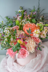 Flower composition in the pink box on table