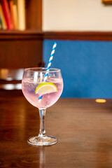 Glass of gin and tonic cocktail served in old vintage Scottisch pub, drinking gin in Edinburgh, UK