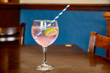 Glass of gin and tonic cocktail served in old vintage Scottisch pub, drinking gin in Edinburgh, UK
