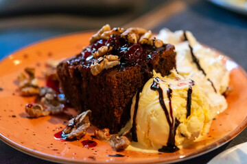 Piece of brownie chocolate cake with vanilla ice cream