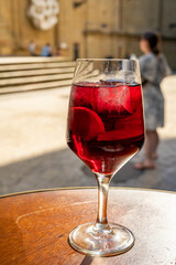 Glass of cold sangria wine served outdoor in bar with view on old street in San Sebastian, Basque Country, Spain