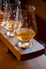 Flight of single malt scotch whisky in glasses served in whiskey bar in Edinburgh, UK