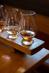 Flight of single malt scotch whisky in glasses served in whiskey bar in Edinburgh, UK