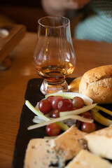 Pairing of scotch whisky and farmers scottish cheeses cheddar, stilton, blue cheese, brie, tasting of whiskey and cheese in Edinburgh, UK