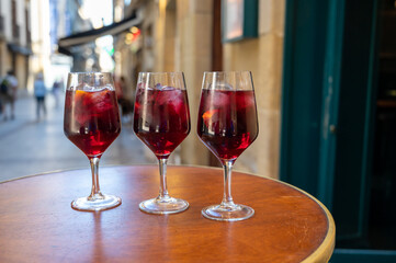 Glasses of cold sangria wine served outdoor in bar with view on old street in San Sebastian, Basque Country, Spain