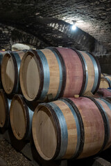 Stages of wine production from fermentation to bottling, visit to wine cellars in Burgundy, France. Aging in wooden barrels.