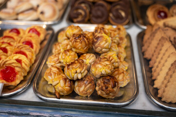 Variety of cookies and cakes on display in artisanal bakery in San Sebastian city, Basque Country, Spain