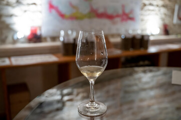 Wine tasting in underground cellars caves of French wine domain in Puligny-Motrachet village, Burgundy, France