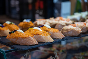 Typical snack of Basque Country and Navarre, pinchos or pinxtos served in bar, small slices of bread upon which ingredient or mixture of ingredients is placed, San Sebastian, Spain
