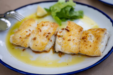 Grilled fillet of white codfish served in fish restaurant in San Sebastian, Basque Country, Spain