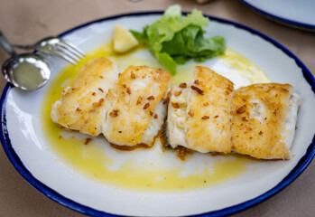 Grilled fillet of white codfish served in fish restaurant in San Sebastian, Basque Country, Spain