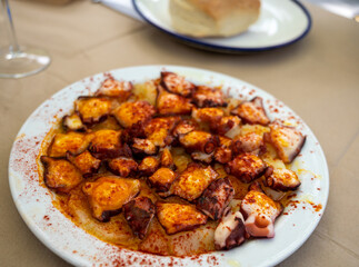 Tasty seafood, grilled octopus galician style with red pimento paprika and potatoes